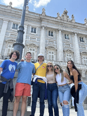 A group of people posing in front of a building.